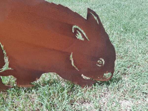 Lifelike rusted metal Wombat Garden Stake measuring 60cm x 42cm, made from Corten steel with a rustic patina for outdoor garden décor.