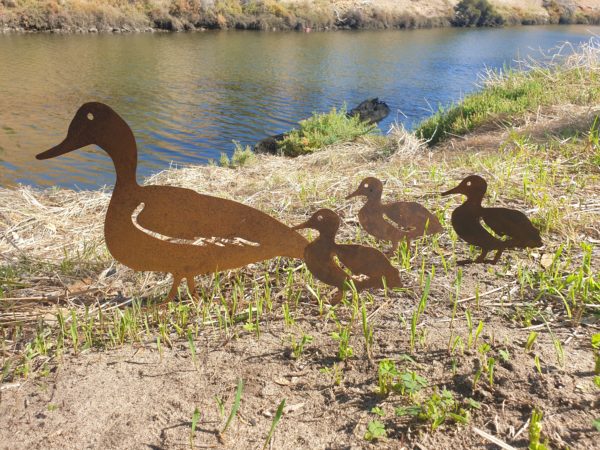 Laser-cut Standing Duck Family Garden Stake featuring a duck and ducklings in weather-resistant Corten steel, with easy-to-install ground spikes.