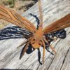 Rusted metal dragonfly garden sculpture