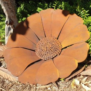 A vibrant Sun Flower With Chain Centre sculpture in a garden, showcasing its beautiful orange-red hues and unique chain centre design.
