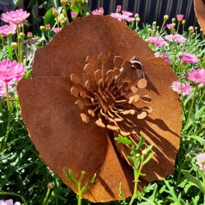 A beautiful rusted metal garden stake featuring a 24cm diameter poppy flower atop a 60cm steel stake. Ideal for adding charm to any outdoor space.